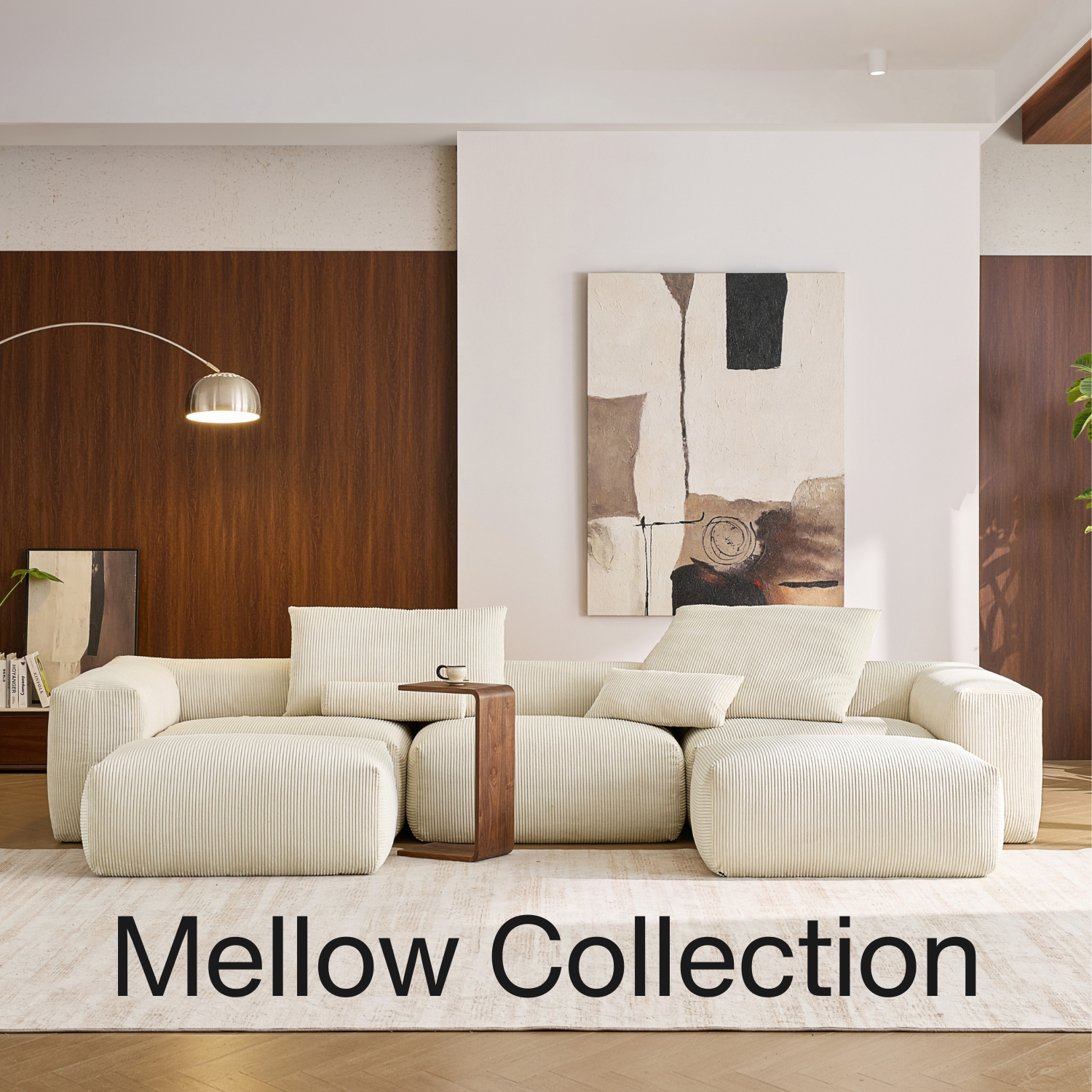 Living room furniture including a white deep cushion couch by Mario Capasa and abstract art on the wall, labeled 'Mellow Collection'.