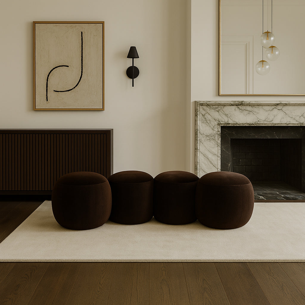 Modern living room with brown pouf chairs, abstract art, and a fireplace.