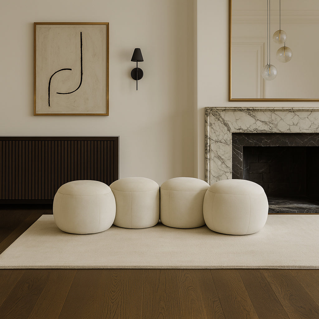 Modern living room with white ottomans, marble fireplace, and abstract art.