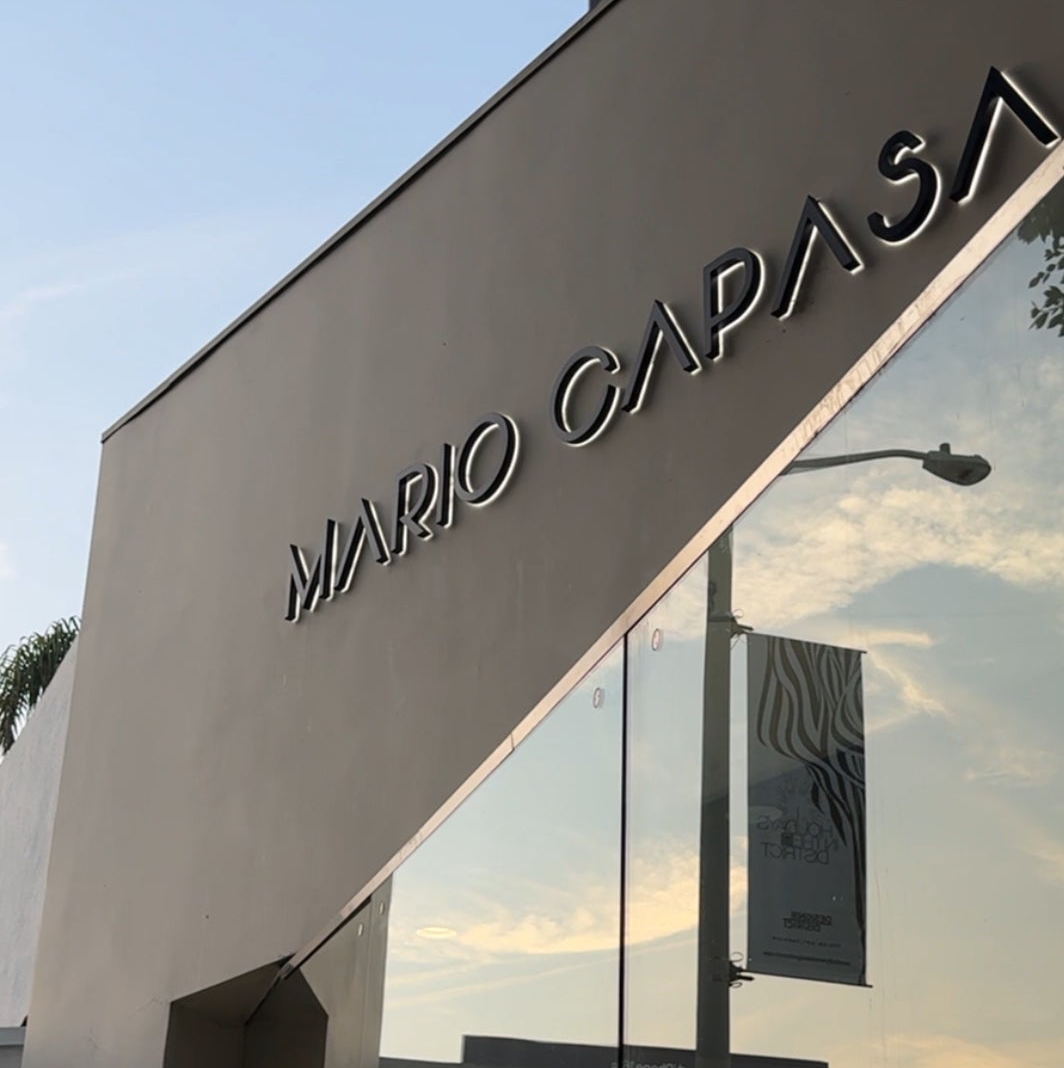 Mario Capasa store entrance with reflective glass facade