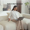 Woman sitting on a low-profile modern couch by Mario Capasa as she spills her drink showing the strength of a stain resistant sofa