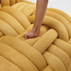 Yellow Armchair being pushed by a hand